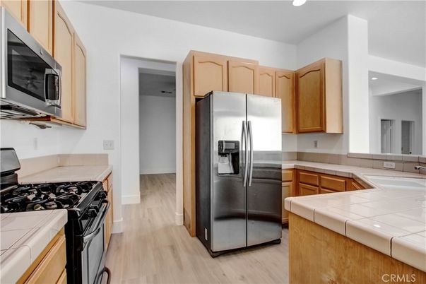 Interior, Kitchen, Recessed Lighting, Tile Countertops, Wood Texture Flooring