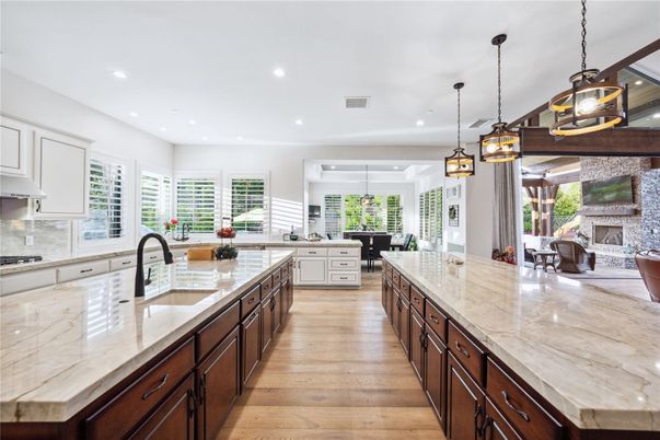 Dining room, Fireplace, Interior, Kitchen, Pendant Lights, Recessed Lighting, Stainless Steel Appliances, Stone Walls, Wood Texture Flooring
