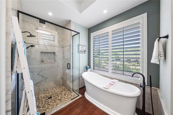 Bathroom, Free Standing Baths, Glass Shower, Interior, Marble Walls, Recessed Lighting, Wood Texture Flooring