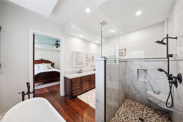 Bathroom, Bedroom, Dual Sink Vanities, Glass Shower, Interior, Marble Walls, Recessed Lighting, Wood Texture Flooring