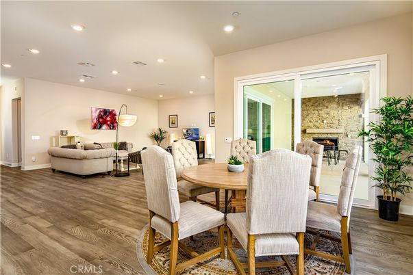 Dining room, Fireplace, Interior, Living room, Recessed Lighting, Stone Walls, Wood Texture Flooring