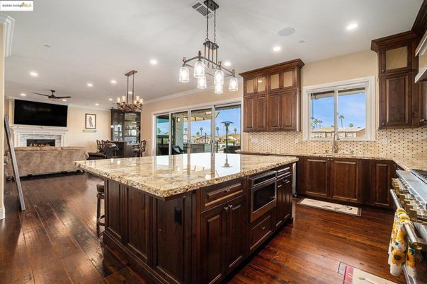 Chandelier, Fireplace, Interior, Kitchen, Living room, Pendant Lights, Recessed Lighting, Wood Texture Flooring