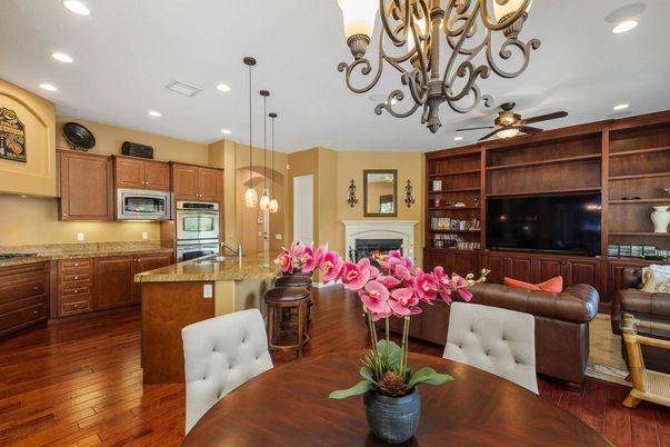 Chandelier, Fireplace, Interior, Kitchen, Living room, Pendant Lights, Recessed Lighting, Stainless Steel Appliances, Wood Texture Flooring