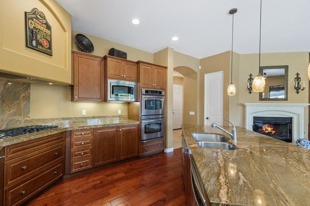 Fireplace, Interior, Kitchen, Pendant Lights, Recessed Lighting, Stainless Steel Appliances, Wood Texture Flooring