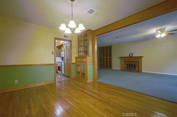 Chandelier, Empty room, Fireplace, Interior, Kitchen, Pendant Lights, Wood Texture Flooring