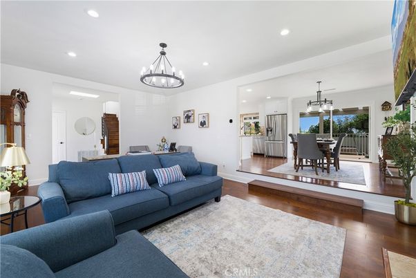 Chandelier, Dining room, Interior, Kitchen, Living room, Pendant Lights, Recessed Lighting, Stainless Steel Appliances, Wood Texture Flooring