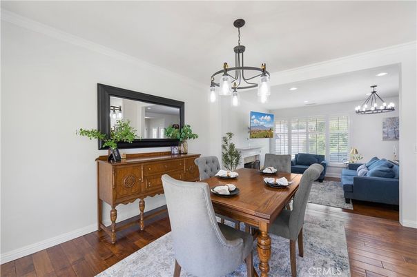 Chandelier, Dining room, Fireplace, Interior, Living room, Pendant Lights, Recessed Lighting, Wood Texture Flooring