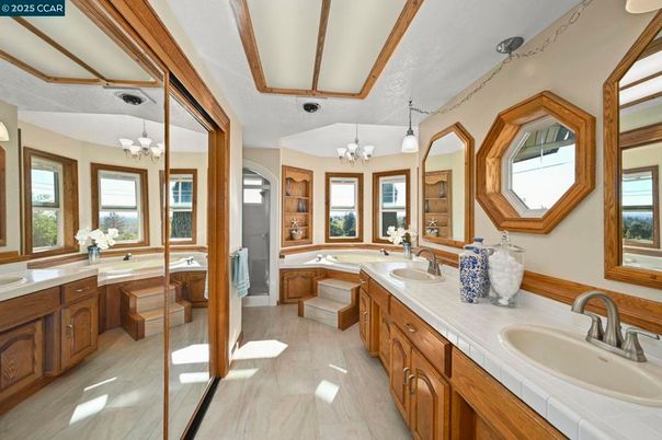 Bathroom, Chandelier, Dual Sink Vanities, Interior, Tile Countertops, Wood Texture Flooring