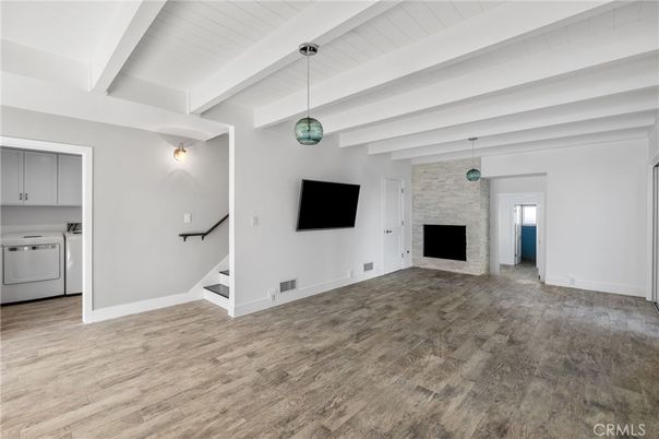 Empty room, Fireplace, Interior, Pendant Lights, Stone Walls, Washer, Wood Texture Flooring
