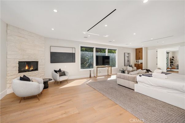 Fireplace, Interior, Living room, Recessed Lighting, Stone Walls, Wood Texture Flooring