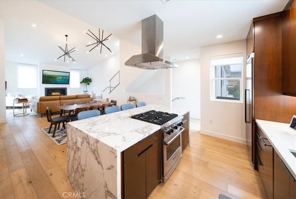 Dining room, Fireplace, Interior, Kitchen, Living room, Pendant Lights, Recessed Lighting, Stainless Steel Appliances, Wood Texture Flooring