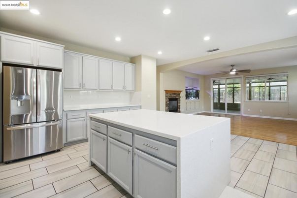 Fireplace, Interior, Kitchen, Recessed Lighting, Stainless Steel Appliances, Wood Texture Flooring