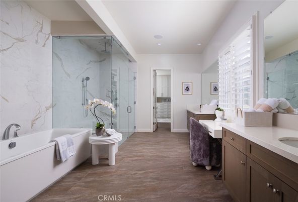 Bathroom, Dual Sink Vanities, Free Standing Baths, Glass Shower, Interior, Marble Walls, Recessed Lighting, Wood Texture Flooring