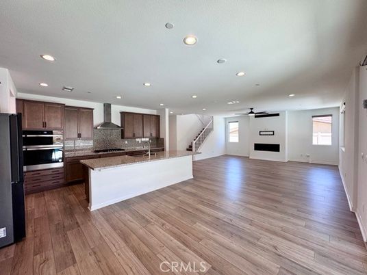 Empty room, Interior, Kitchen, Recessed Lighting, Stainless Steel Appliances, Wood Texture Flooring