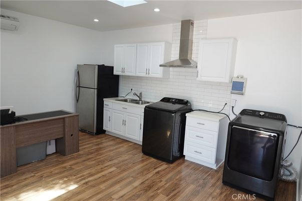 Interior, Kitchen, Recessed Lighting, Washer, Wood Texture Flooring