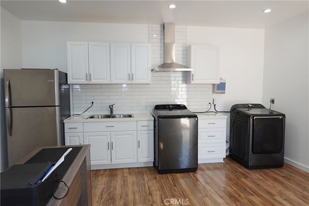 Interior, Kitchen, Recessed Lighting, Washer, Wood Texture Flooring