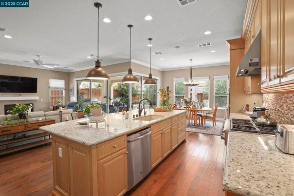Chandelier, Dining room, Fireplace, Interior, Kitchen, Living room, Pendant Lights, Recessed Lighting, Stainless Steel Appliances, Wood Texture Flooring