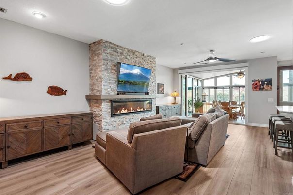 Dining room, Fireplace, Interior, Living room, Recessed Lighting, Stone Walls, Wood Texture Flooring