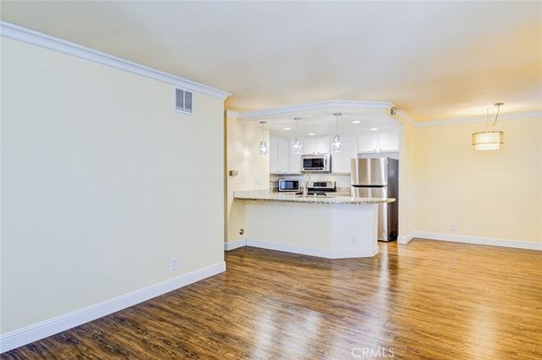 Empty room, Interior, Kitchen, Pendant Lights, Recessed Lighting, Stainless Steel Appliances, Wood Texture Flooring