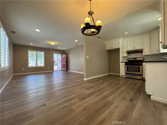Empty room, Interior, Kitchen, Pendant Lights, Recessed Lighting, Stainless Steel Appliances, Wood Texture Flooring