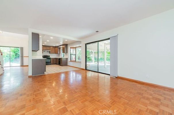 Empty room, Interior, Kitchen, Recessed Lighting, Stainless Steel Appliances, Wood Texture Flooring