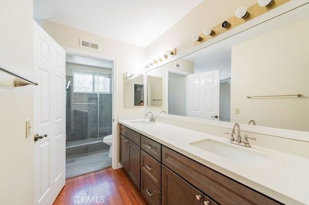 Bathroom, Dual Sink Vanities, Glass Shower, Interior, Wood Texture Flooring