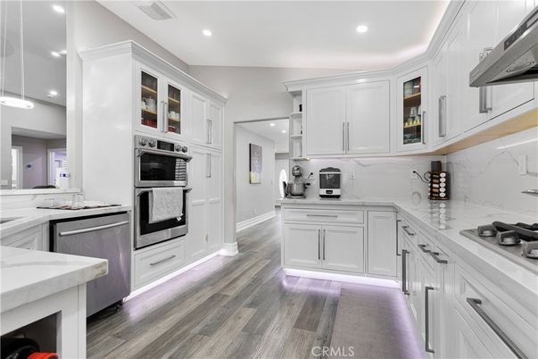 Interior, Kitchen, Marble Walls, Recessed Lighting, Stainless Steel Appliances, Wood Texture Flooring