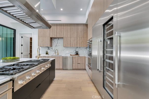 Interior, Kitchen, Marble Walls, Recessed Lighting, Stainless Steel Appliances, Wood Texture Flooring
