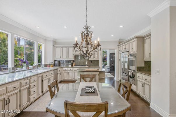 Chandelier, Dining room, Interior, Kitchen, Recessed Lighting, Stainless Steel Appliances, Wood Texture Flooring
