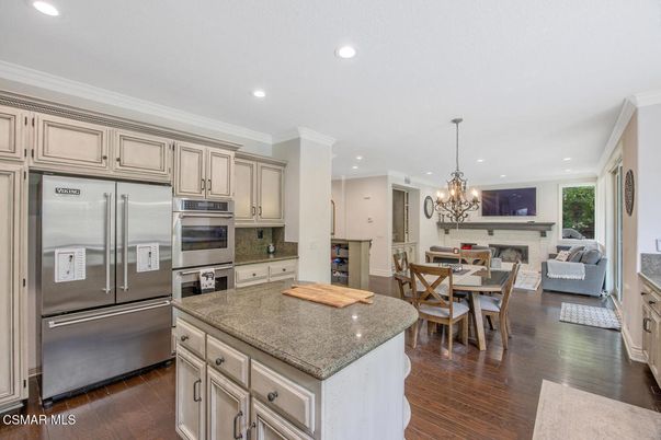 Chandelier, Dining room, Fireplace, Interior, Kitchen, Living room, Recessed Lighting, Stainless Steel Appliances, Wood Texture Flooring