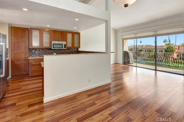 Empty room, Interior, Kitchen, Recessed Lighting, Stainless Steel Appliances, Wood Texture Flooring