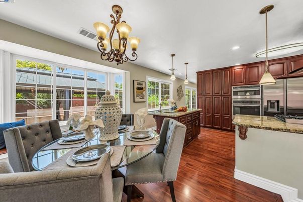 Chandelier, Dining room, Interior, Kitchen, Pendant Lights, Recessed Lighting, Stainless Steel Appliances, Wood Texture Flooring