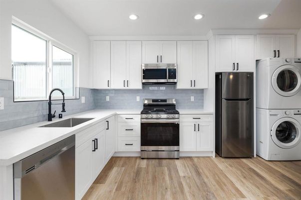 Interior, Kitchen, Recessed Lighting, Stainless Steel Appliances, Washer, Wood Texture Flooring
