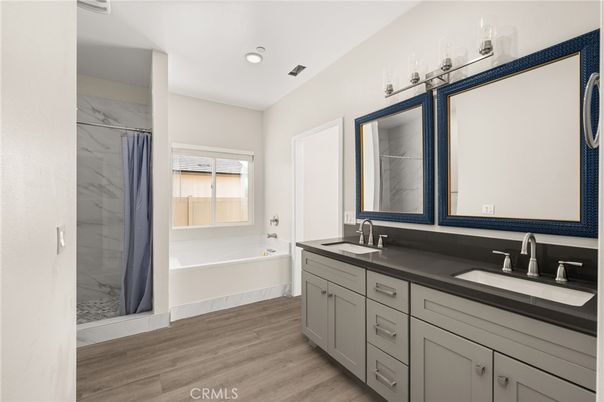 Bathroom, Dual Sink Vanities, Interior, Marble Walls, Recessed Lighting, Wood Texture Flooring