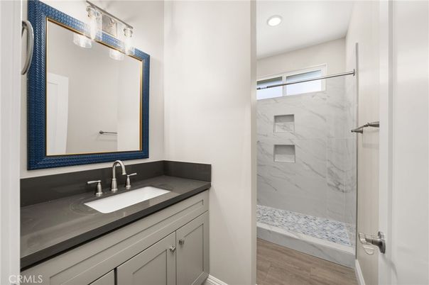 Bathroom, Glass Shower, Interior, Marble Walls, Recessed Lighting, Wood Texture Flooring