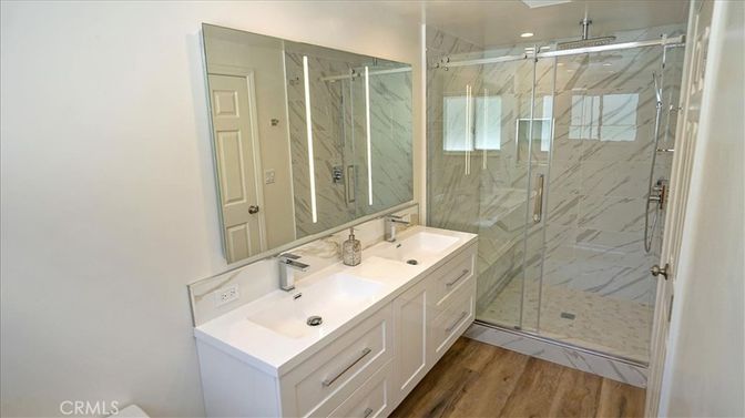 Bathroom, Dual Sink Vanities, Glass Shower, Interior, Marble Walls, Recessed Lighting, Wood Texture Flooring
