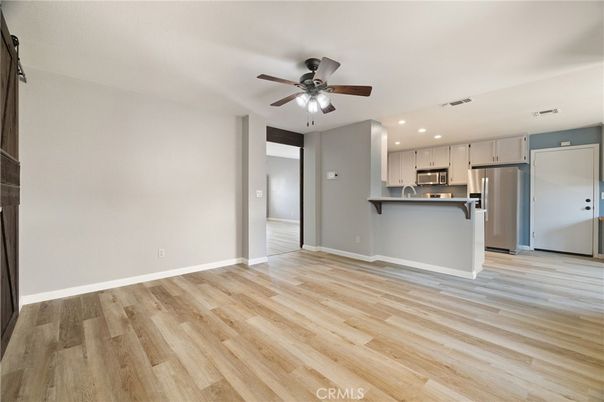 Empty room, Interior, Kitchen, Recessed Lighting, Stainless Steel Appliances, Wood Texture Flooring