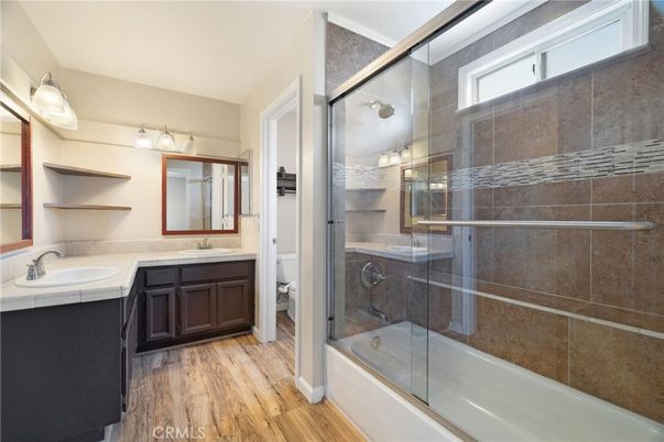 Bathroom, Dual Sink Vanities, Glass Shower, Interior, Tile Countertops, Wood Texture Flooring