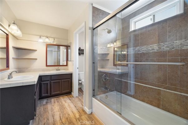 Bathroom, Dual Sink Vanities, Glass Shower, Interior, Tile Countertops, Wood Texture Flooring
