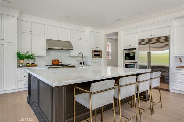 Interior, Kitchen, Marble Walls, Recessed Lighting, Stainless Steel Appliances, Wood Texture Flooring