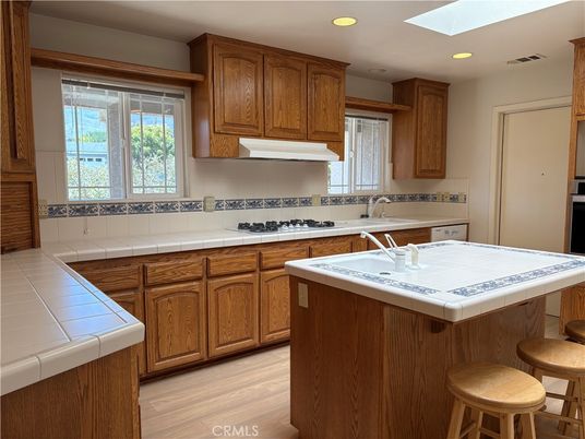 Interior, Kitchen, Recessed Lighting, Tile Countertops, Wood Texture Flooring
