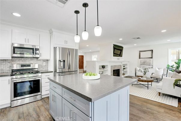 Fireplace, Interior, Kitchen, Living room, Pendant Lights, Recessed Lighting, Stainless Steel Appliances, Wood Texture Flooring