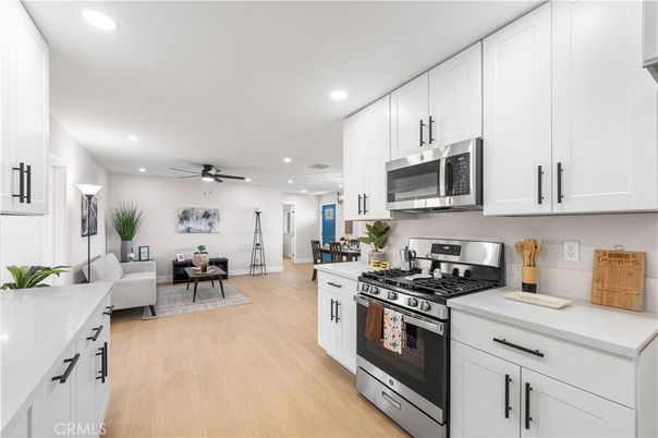 Dining room, Interior, Kitchen, Living room, Recessed Lighting, Stainless Steel Appliances, Wood Texture Flooring