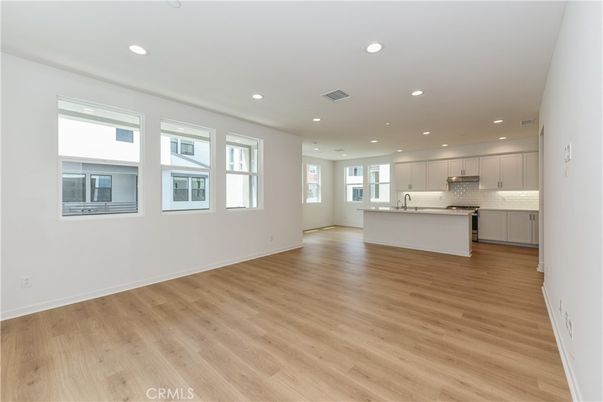 Empty room, Interior, Kitchen, Recessed Lighting, Stainless Steel Appliances, Wood Texture Flooring
