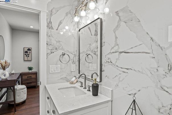 Bathroom, Dual Sink Vanities, Interior, Marble Walls, Recessed Lighting, Wood Texture Flooring