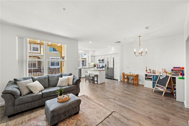 Chandelier, Dining room, Interior, Kitchen, Living room, Pendant Lights, Recessed Lighting, Stainless Steel Appliances, Wood Texture Flooring