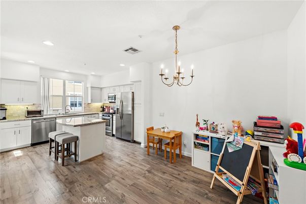 Chandelier, Dining room, Interior, Kitchen, Pendant Lights, Recessed Lighting, Stainless Steel Appliances, Wood Texture Flooring