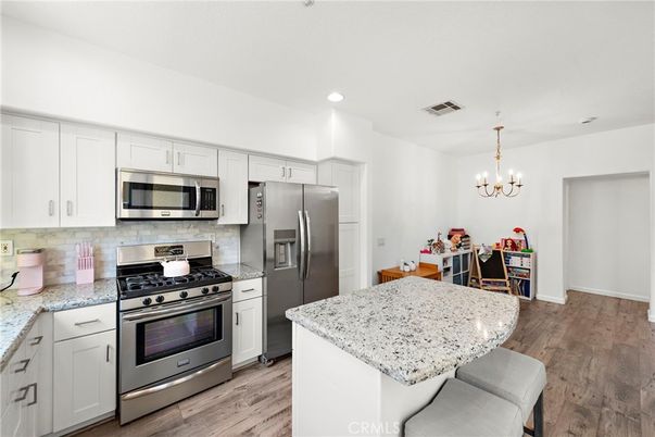 Chandelier, Dining room, Interior, Kitchen, Recessed Lighting, Stainless Steel Appliances, Wood Texture Flooring
