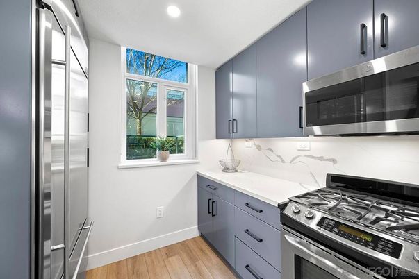 Interior, Kitchen, Marble Walls, Recessed Lighting, Stainless Steel Appliances, Wood Texture Flooring