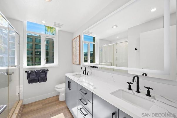 Bathroom, Dual Sink Vanities, Glass Shower, Interior, Recessed Lighting, Wood Texture Flooring